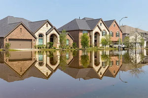 Large brick houses on a flooded street.
