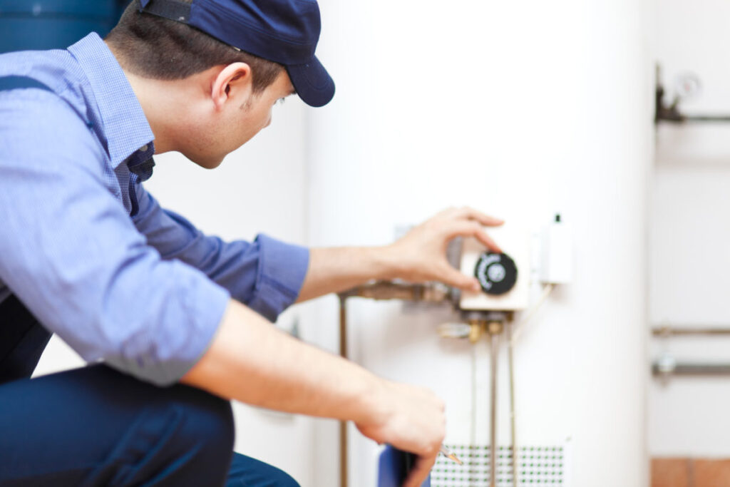 close-up of plumber installing water heater in home